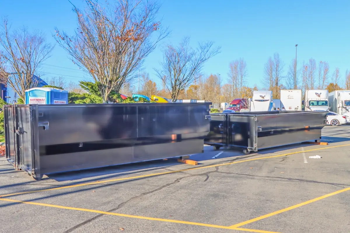 Professional dumpster rental service with roll-off container on residential driveway in Edison